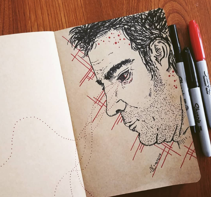 Drawing of a depressed man looking down in sketch book